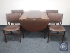 A Danish mahogany effect flap sided dining table with two leaves,