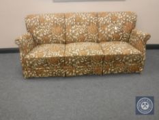 A mid 20th century continental three seater settee upholstered in a floral fabric