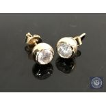 A pair of 14ct yellow gold diamond earrings featuring two round brilliant cut diamonds 1.0ct.