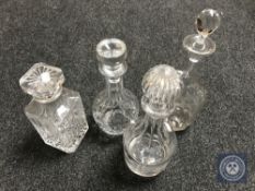 Five glass decanters with stoppers