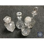 Five glass decanters with stoppers