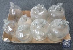 A box of glass demijohns and bottles