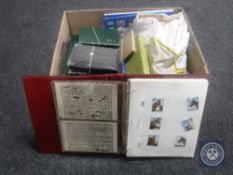 A box of folders and books containing stamps,