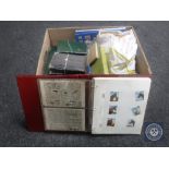 A box of folders and books containing stamps,