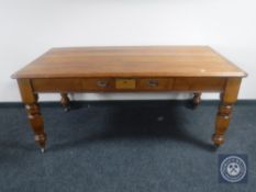 A Victorian pine dining table fitted with a drawer