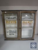 An antique pine double door wall cabinet painted with Hovis advertisement