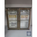 An antique pine double door wall cabinet painted with Hovis advertisement