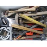 A crate of hand tools and hammers