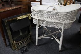 A wicker basket on stand and a brass framed coal effect electric fire