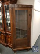A leaded glass door oak corner cabinet,