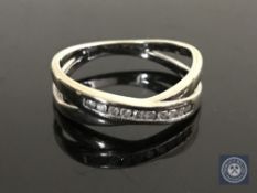 A 9ct gold diamond set crossover ring, size K CONDITION REPORT: 2.