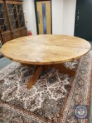 An impressive circular pine dining table,