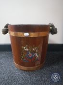 An oak coopered bucket with rope handle bearing a coat of arms