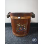 An oak coopered bucket with rope handle bearing a coat of arms