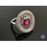 An 18ct white gold ruby and diamond ring, featuring one round cut natural ruby 1.