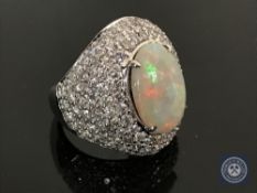 An 18ct white gold opal cocktail ring featuring a cabochon opal 4.