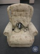 An electric reclining armchair upholstered in a floral fabric