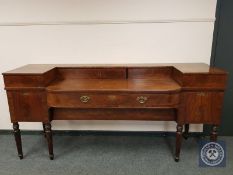 A late George III bow fronted sideboard on tapered legs,
