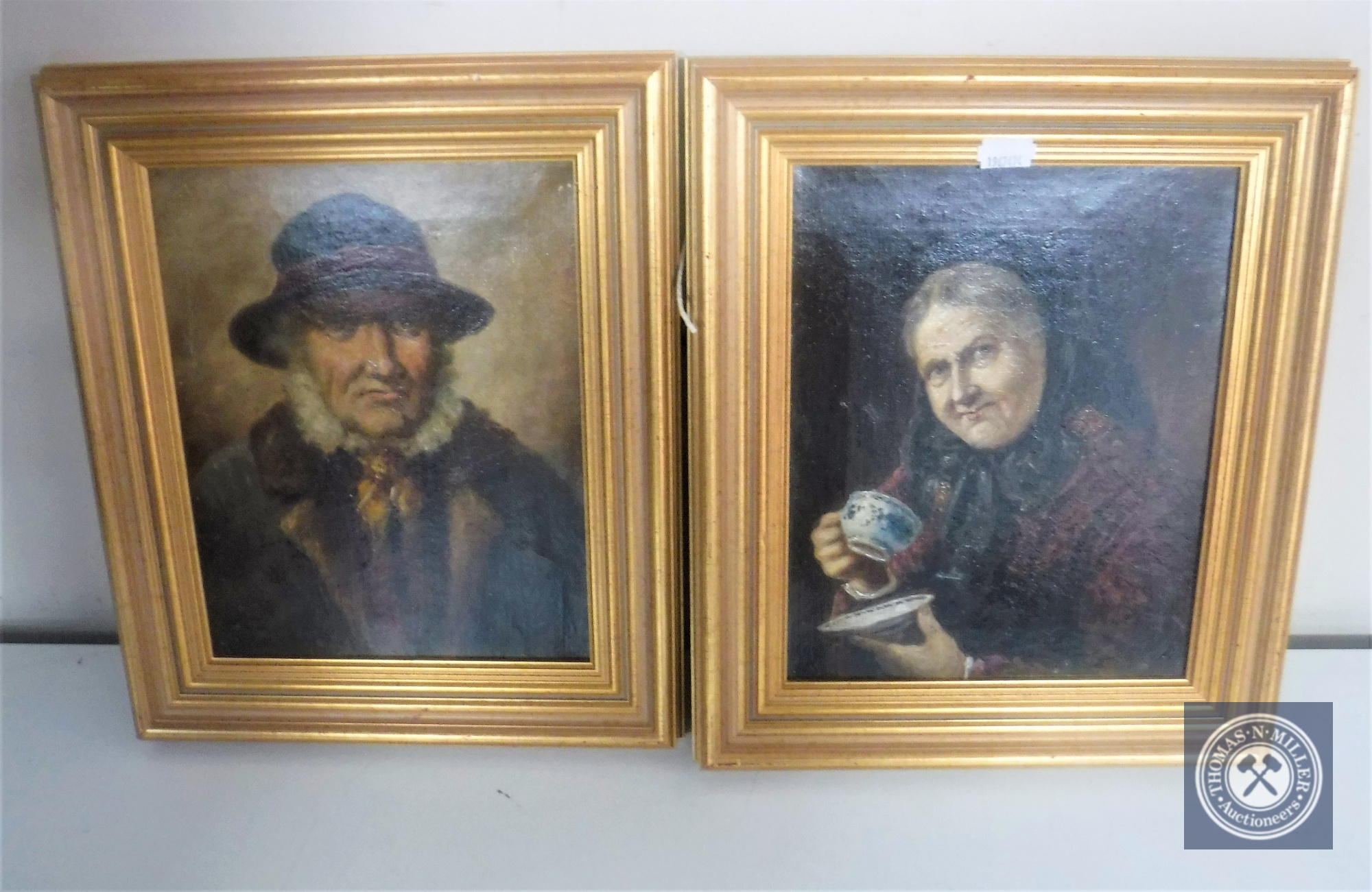 A pair of continental school oil on canvas portraits