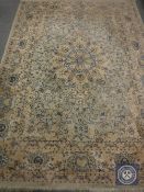 A fringed Eastern style carpet on cream ground