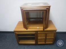 A nest of three teak tiled topped tables and an audio cabinet