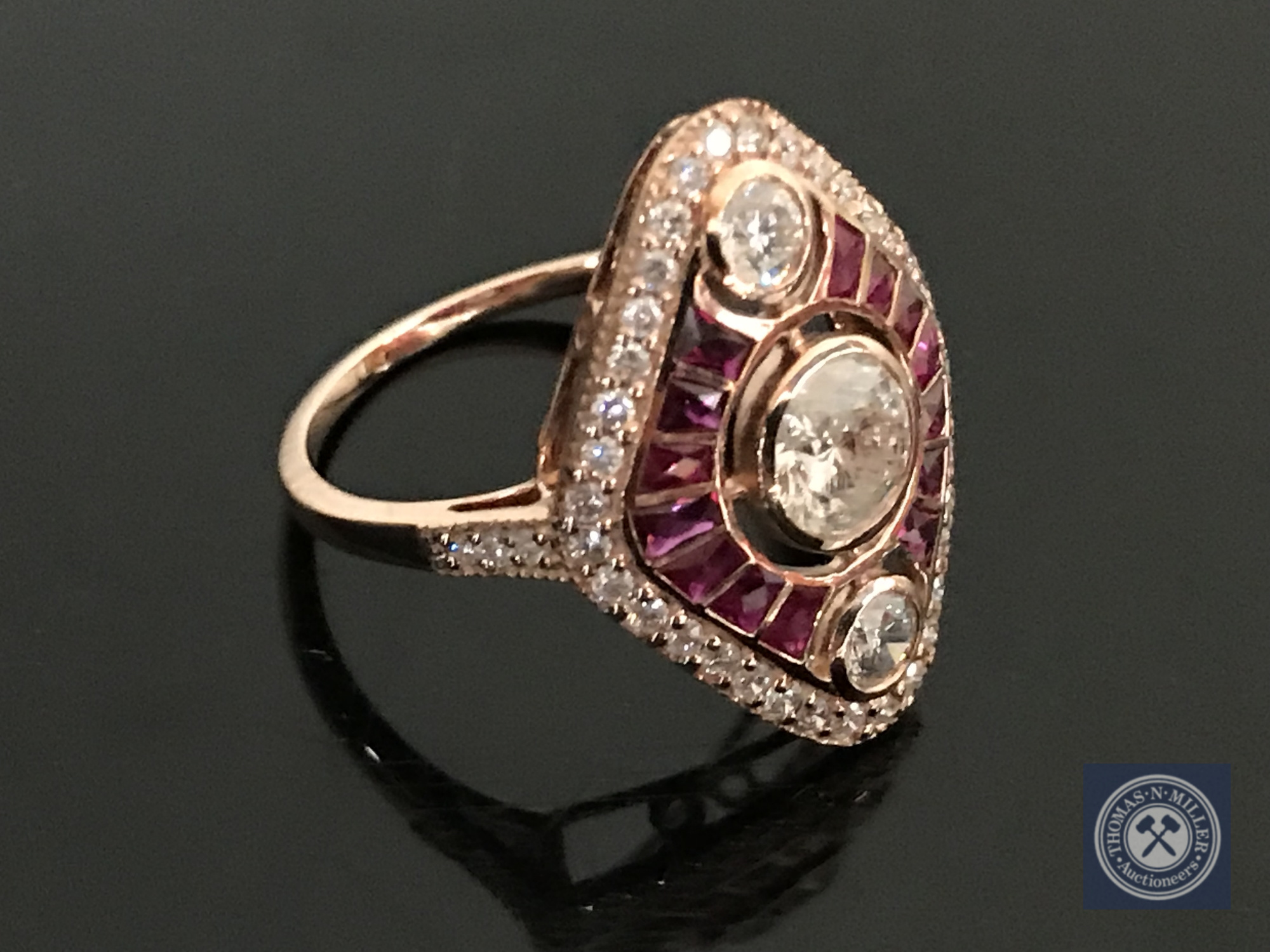A 14ct rose gold ruby and diamond ring, featuring 1 round brilliant cut diamond 0.