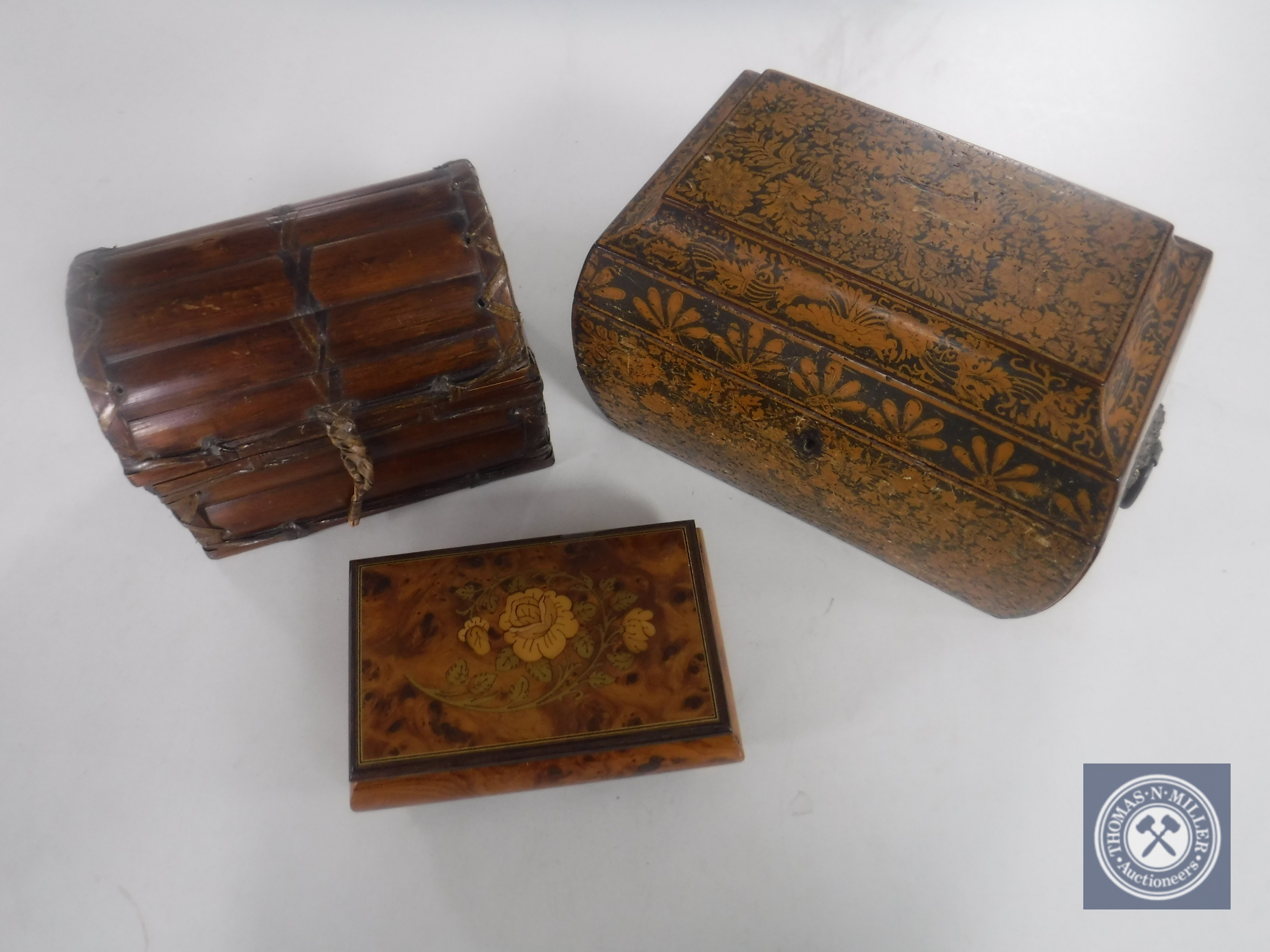 An early 20th century tea caddy and two trinket boxes