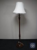 A mahogany standard lamp and shade