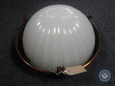 An Art Deco style light fitting with opaque glass shade