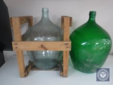 Two glass carboys (one in wooden crate)
