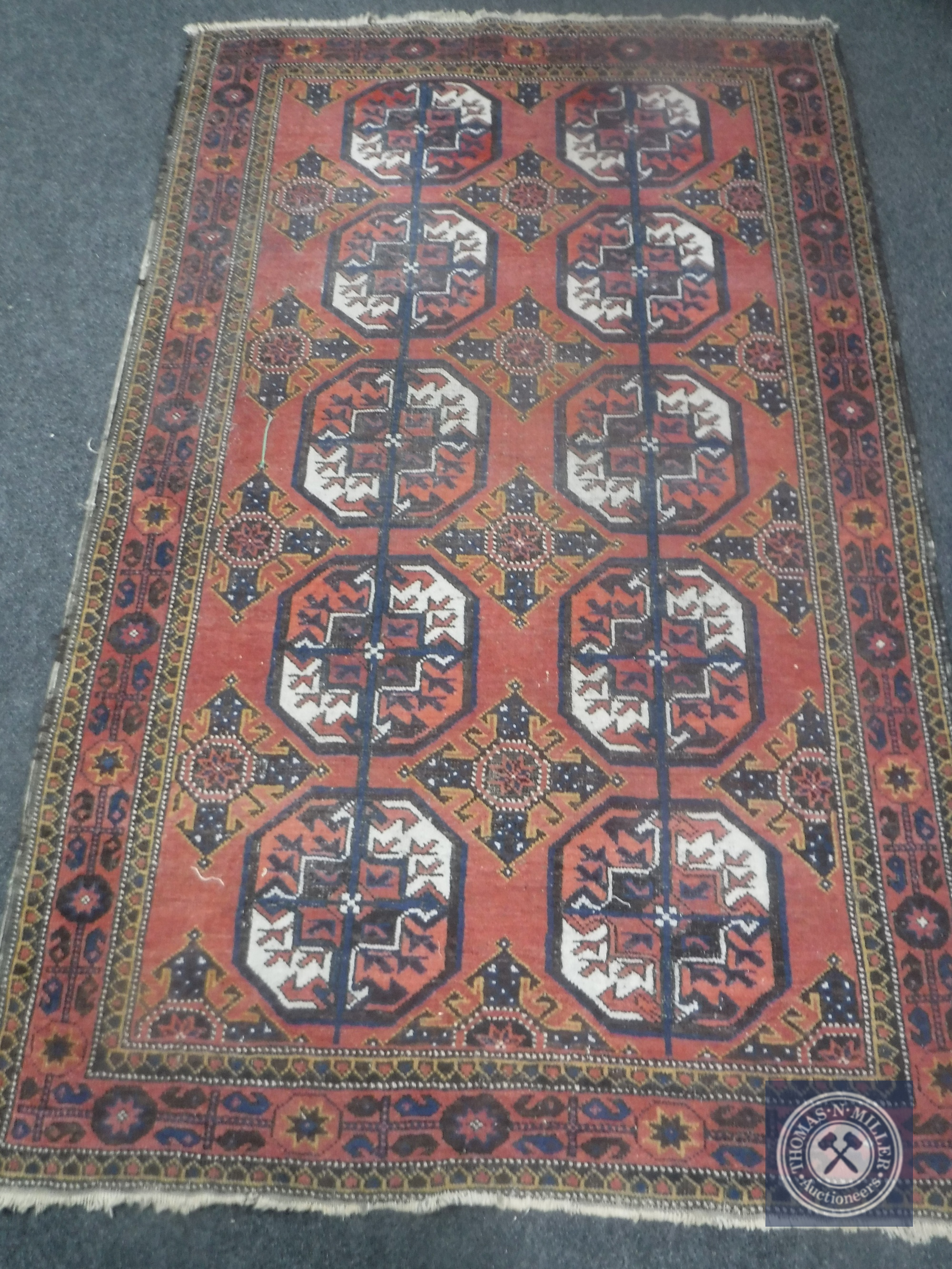 An Afghan Bokhara rug on salmon ground,