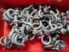 A crate of metal coupling hooks
