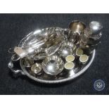 A plated twin handled gallery tray containing plated items, basket, napkin rings,