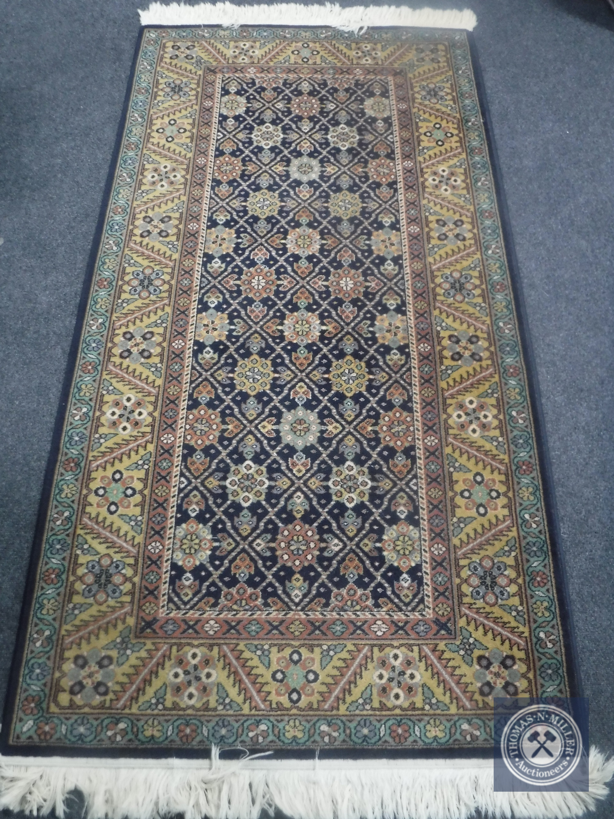 A Caucasian design rug on indigo ground,
