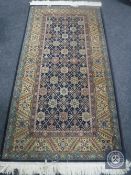 A Caucasian design rug on indigo ground,