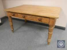 A pine farmhouse kitchen table fitted two drawers