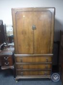 A walnut wardrobe fitted three drawers beneath