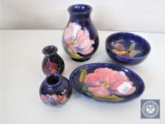 Five pieces of Moorcroft pottery including three miniature vases,