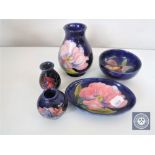 Five pieces of Moorcroft pottery including three miniature vases,