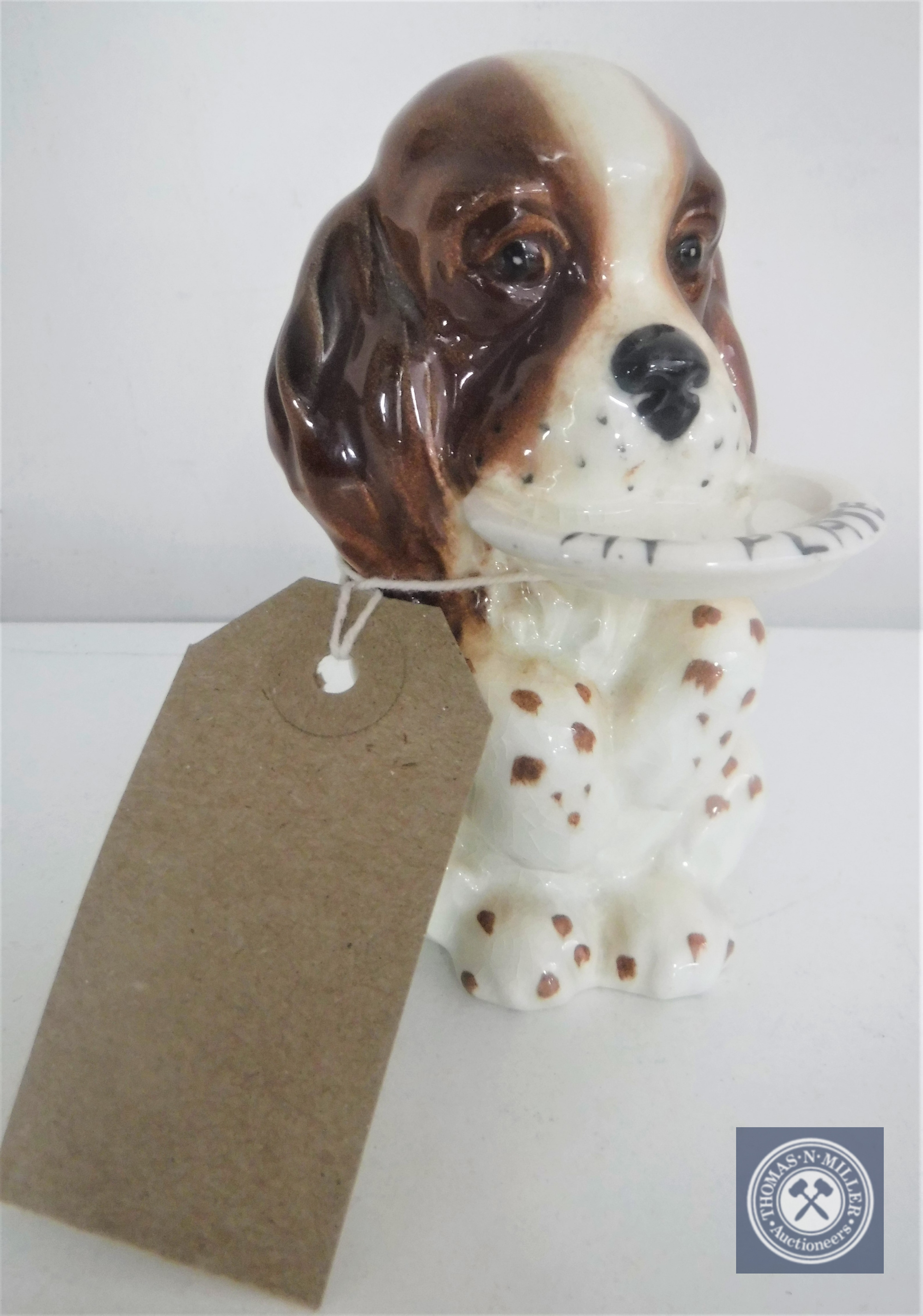 A Beswick china dog figure, "My Plate", height 10 cm.