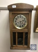 A continental Youngmans oak wall clock with silvered dial