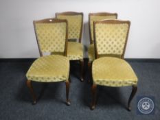 Four dining chairs upholstered in gold fabric