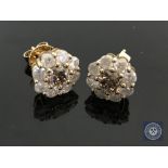 A pair of 18ct yellow gold diamond stud earrings featuring two round brilliant cut cognac diamonds