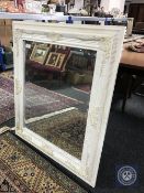 A Victorian style white framed mirror