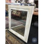 A Victorian style white framed mirror