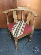 A continental oak corner armchair