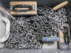 A box of plastering skimmers and chains