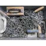 A box of plastering skimmers and chains