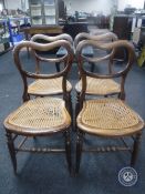 A set of four rosewood bergere seated dining chairs