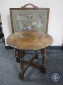 A circular oak coffee table and tapestry fire screen CONDITION REPORT: This is an